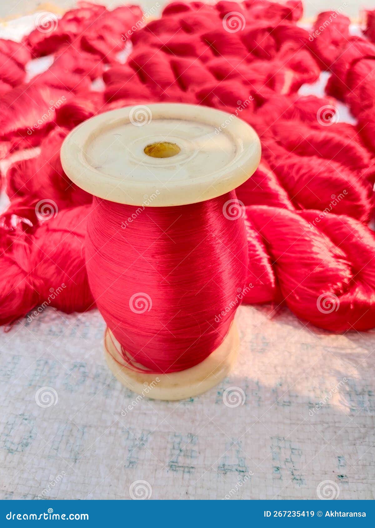 close up background spool of sewing threads colorful sortÃÂ ..close up spool of sewing expensive red silk threads colorful sort